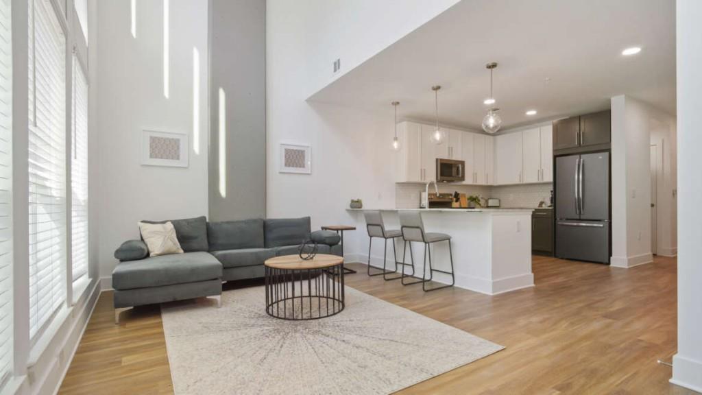 a living room with furniture and kitchen view