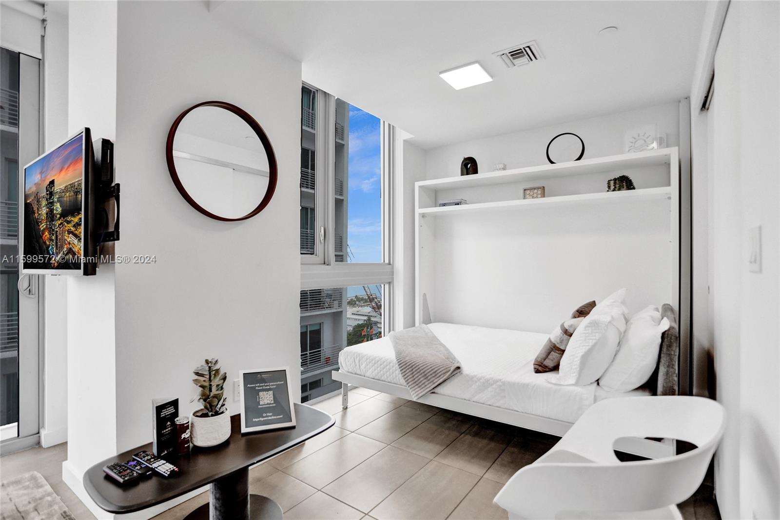 a living room with furniture and a mirror