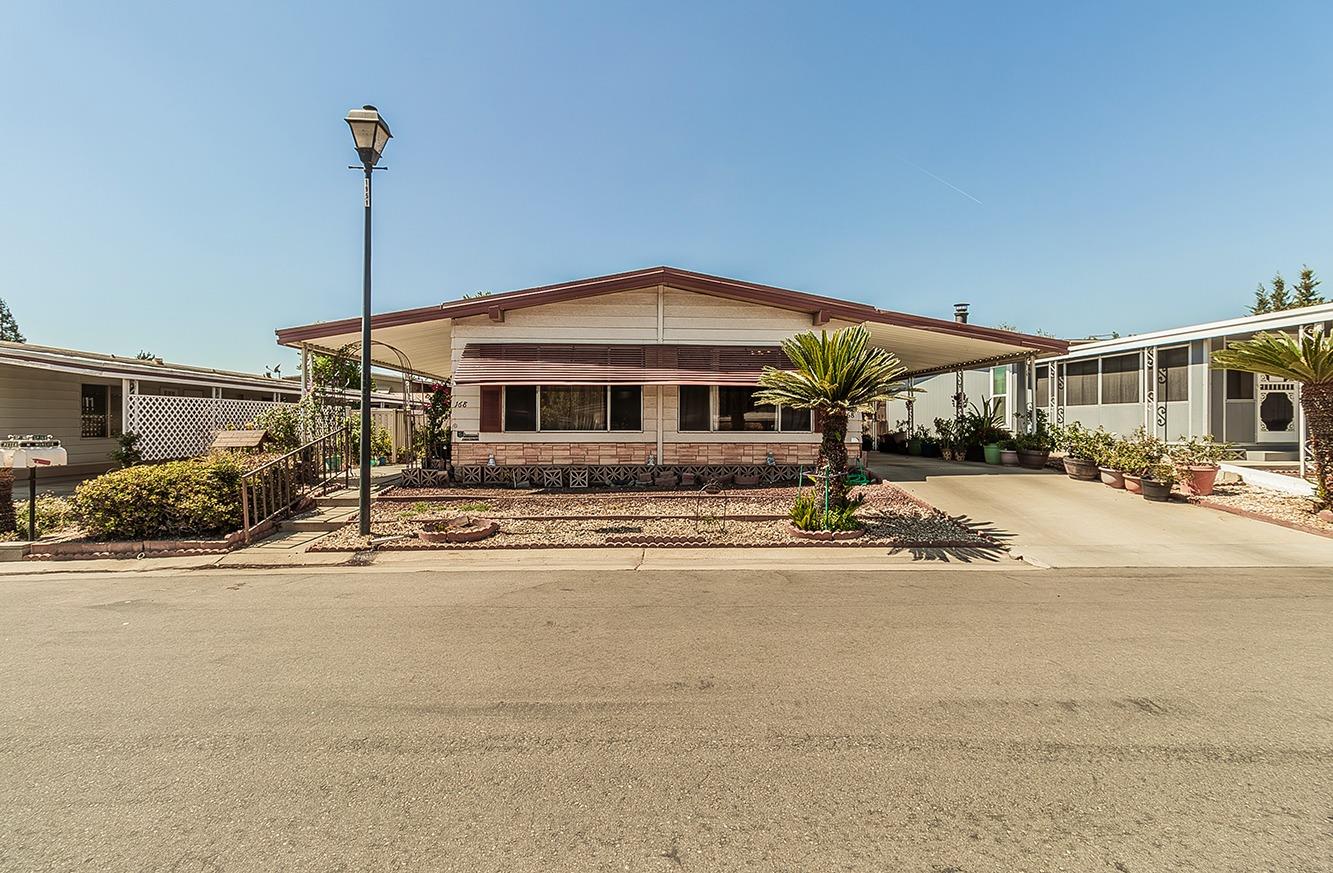 a front view of a house with a garden