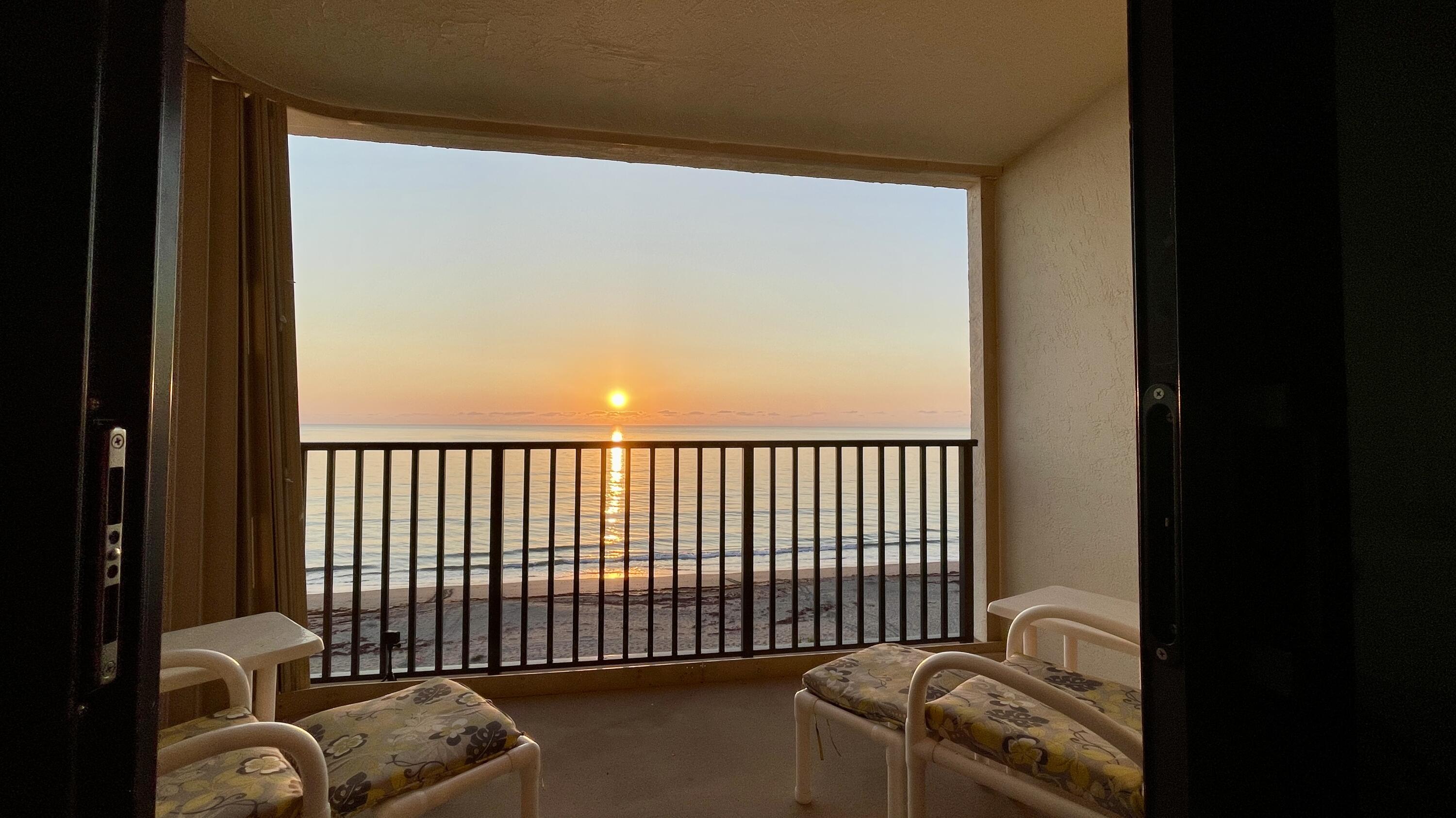 a view of a balcony with furniture