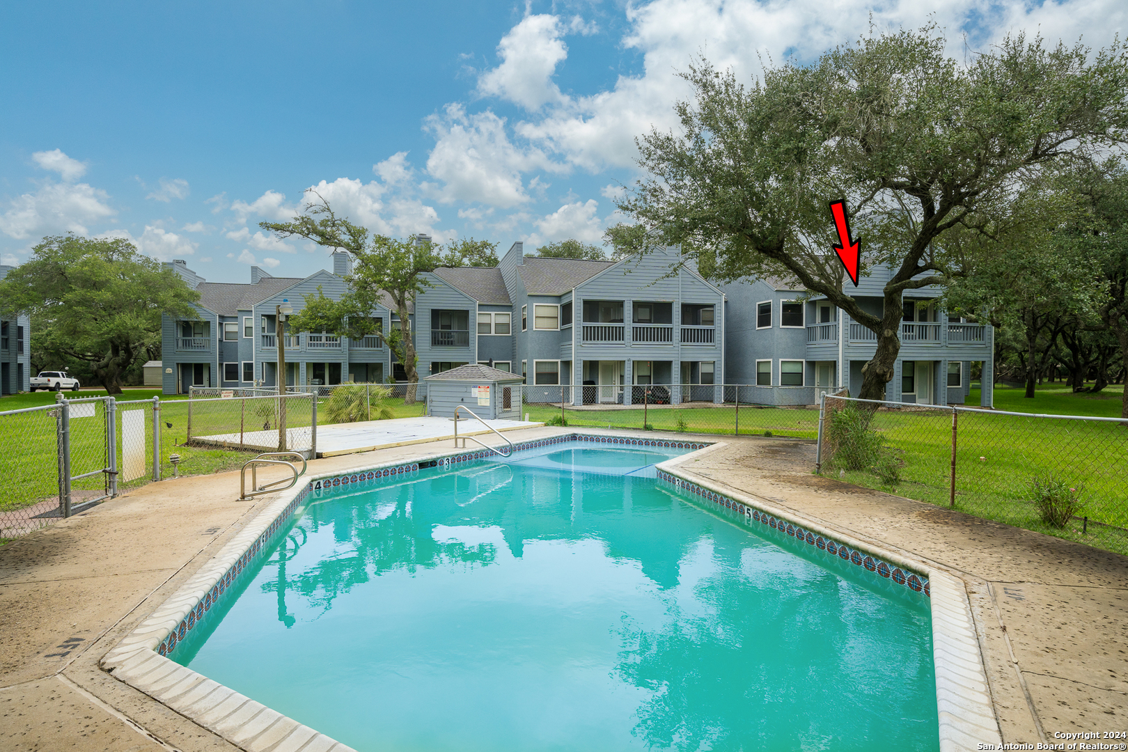 a view of a house with swimming pool and a yard