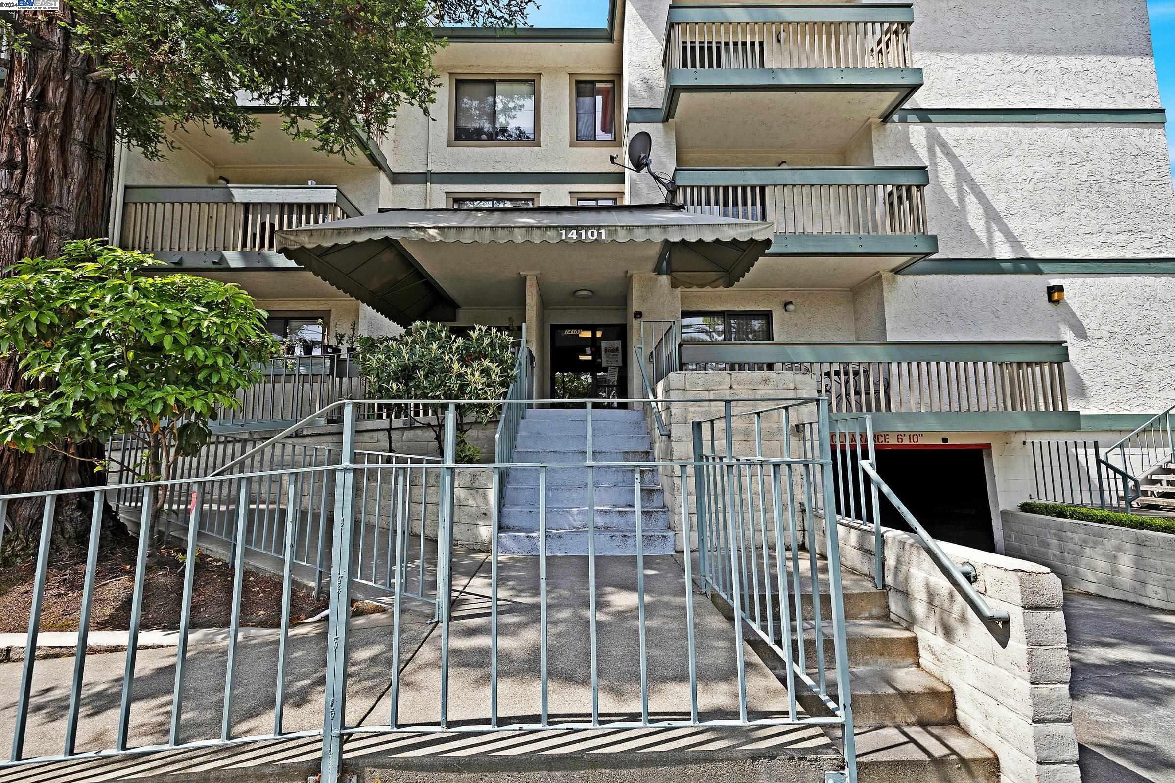 a view of a balcony with iron stairs