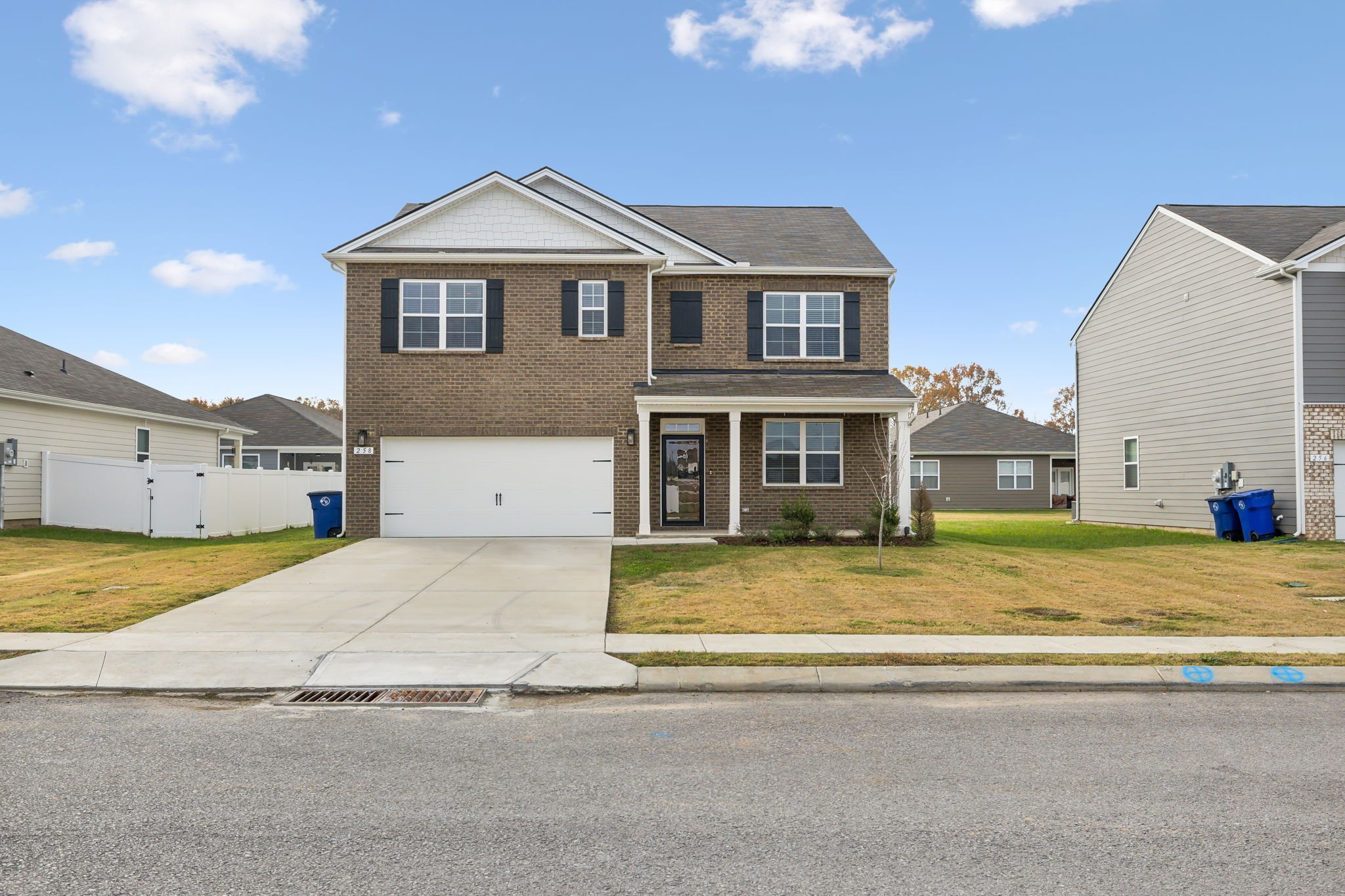 a front view of a house with a yard and a garage