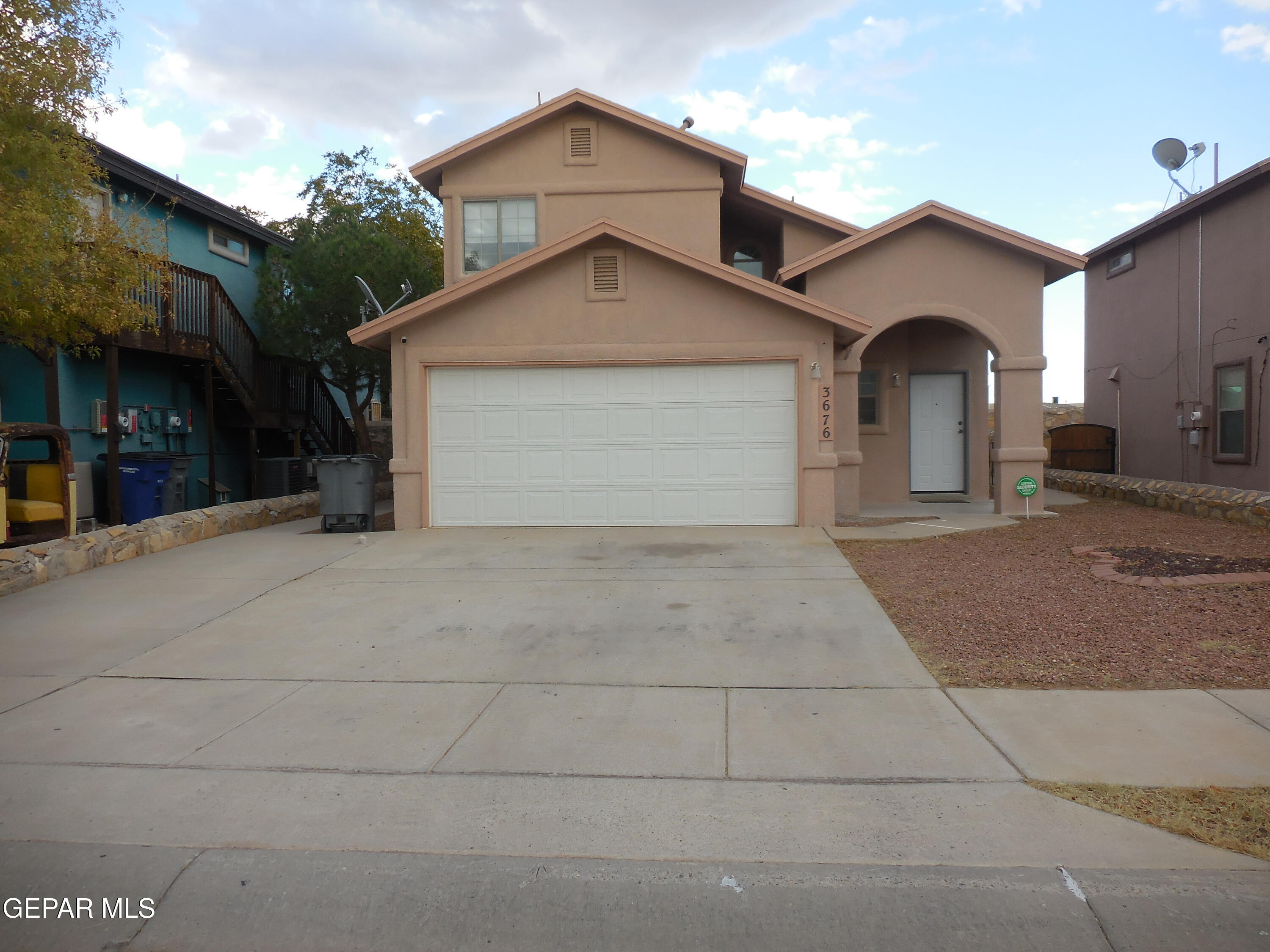 a view of a house with a yard and garage