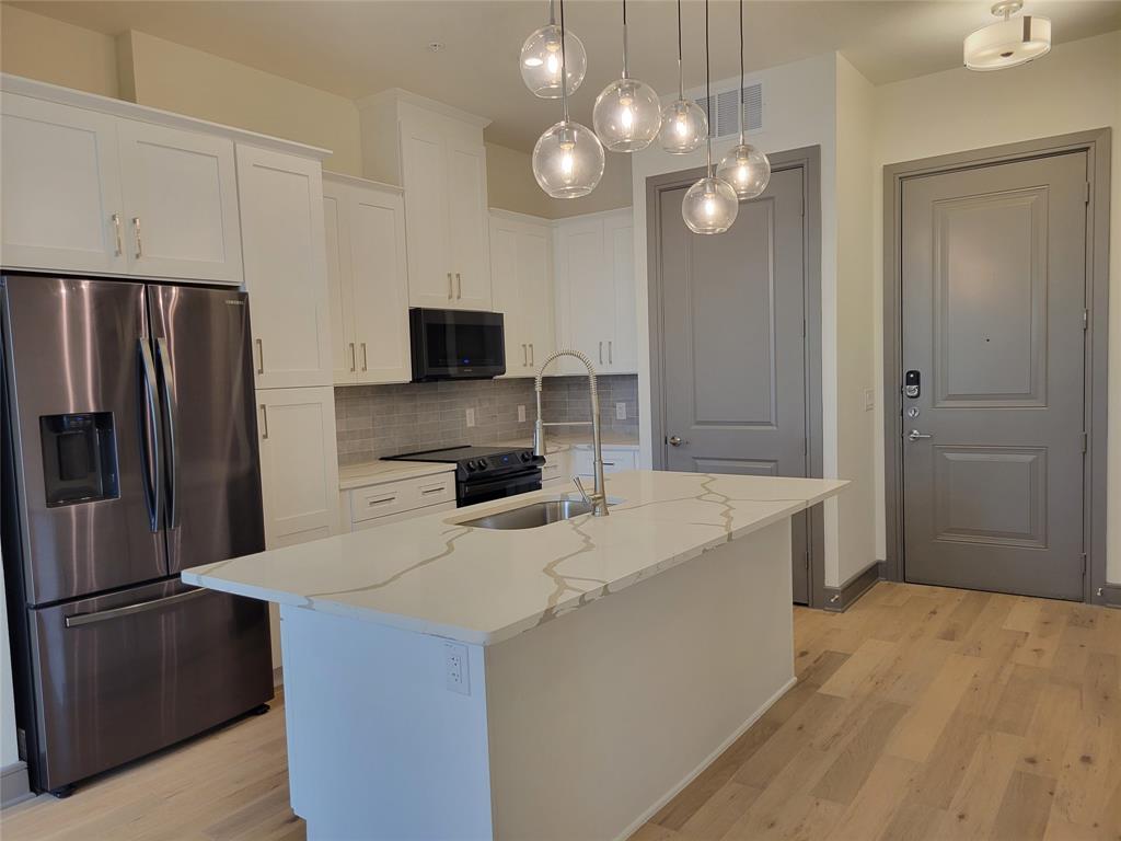 a kitchen with a refrigerator a sink and dishwasher