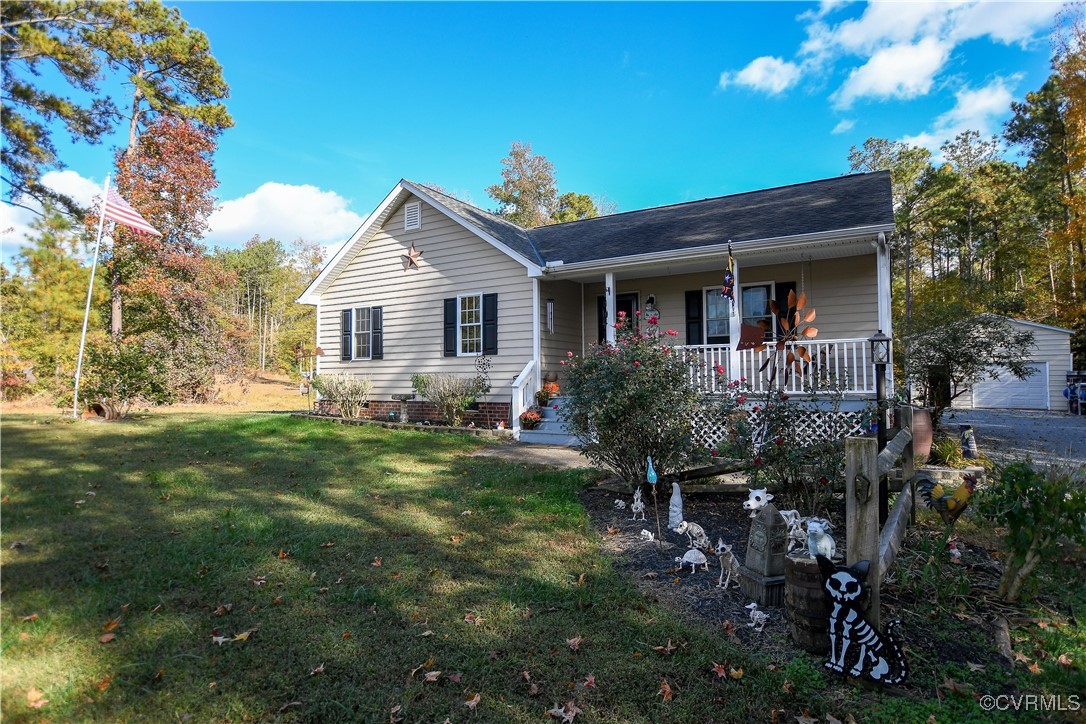 View of front facade with a porch and a front lawn