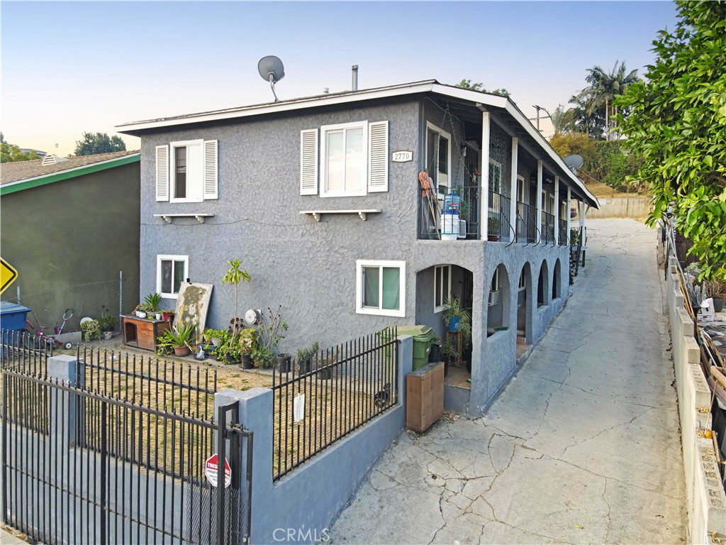 a front view of house yard with balcony