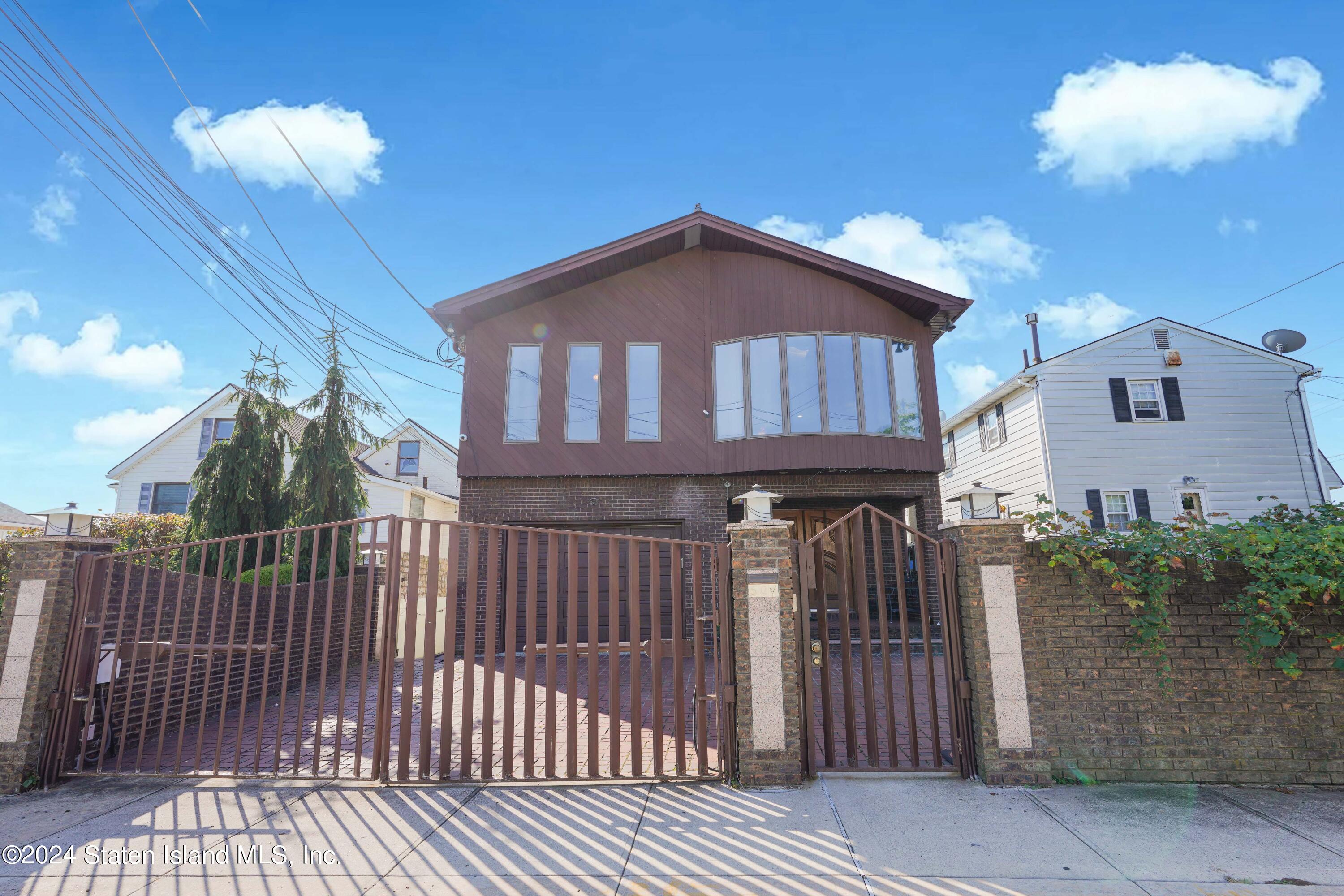 a view of a house with wooden fence