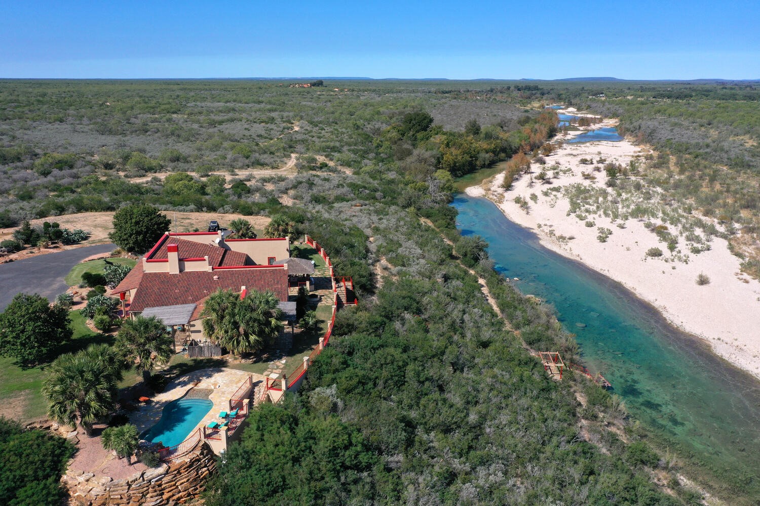 an aerial view of residential houses with outdoor space and river