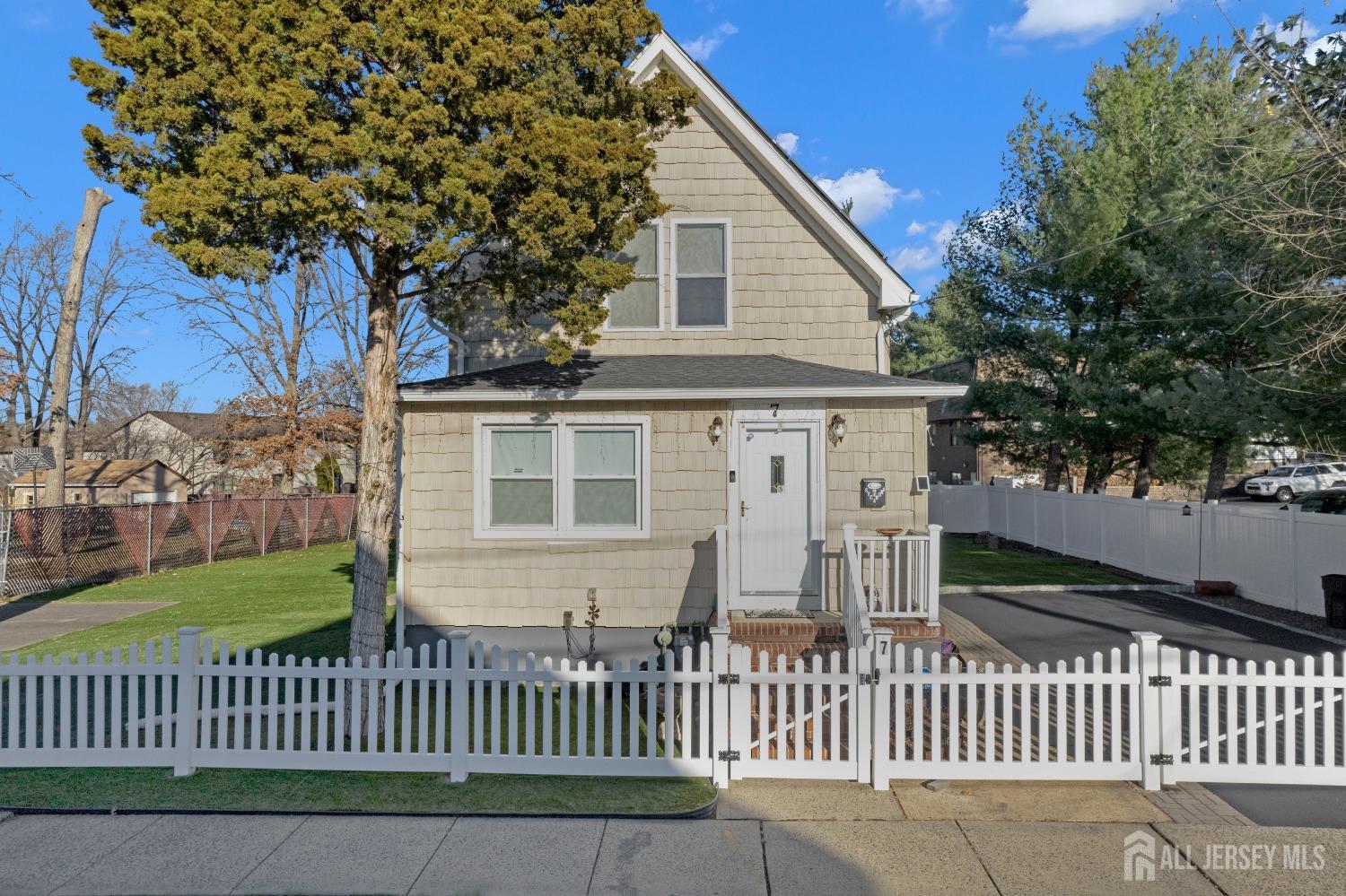 a view of a house with wooden fence