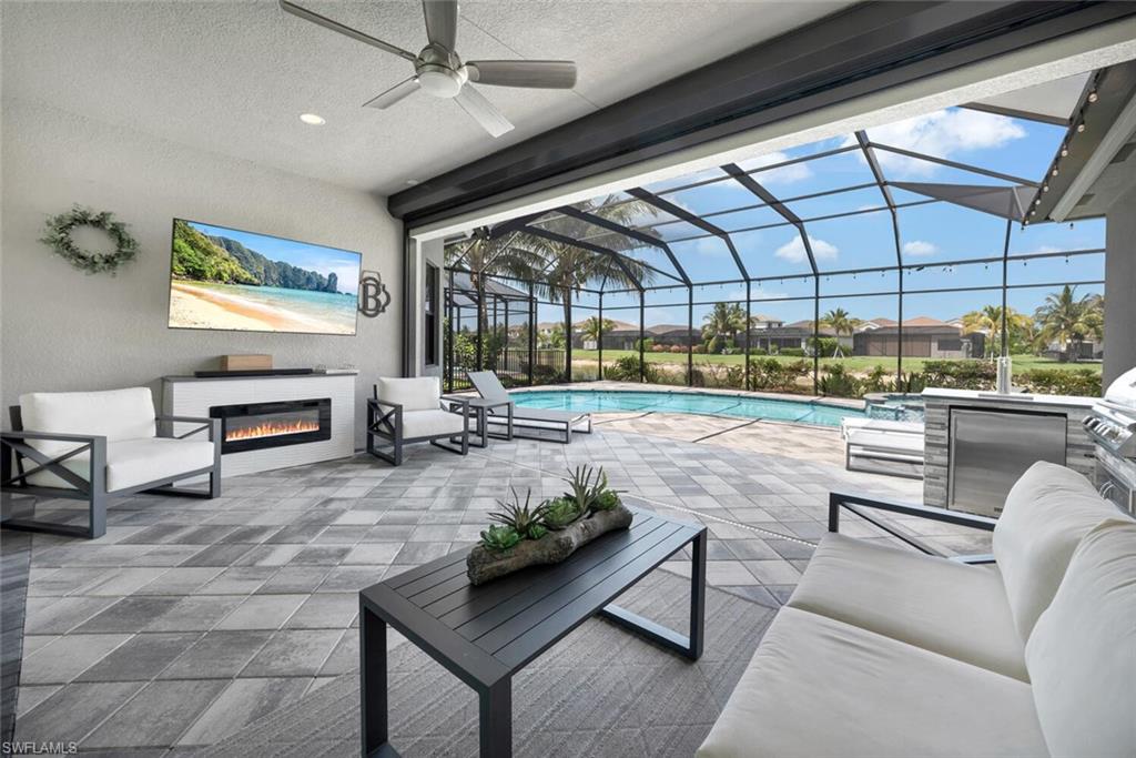 a living room with patio furniture and a flat screen tv