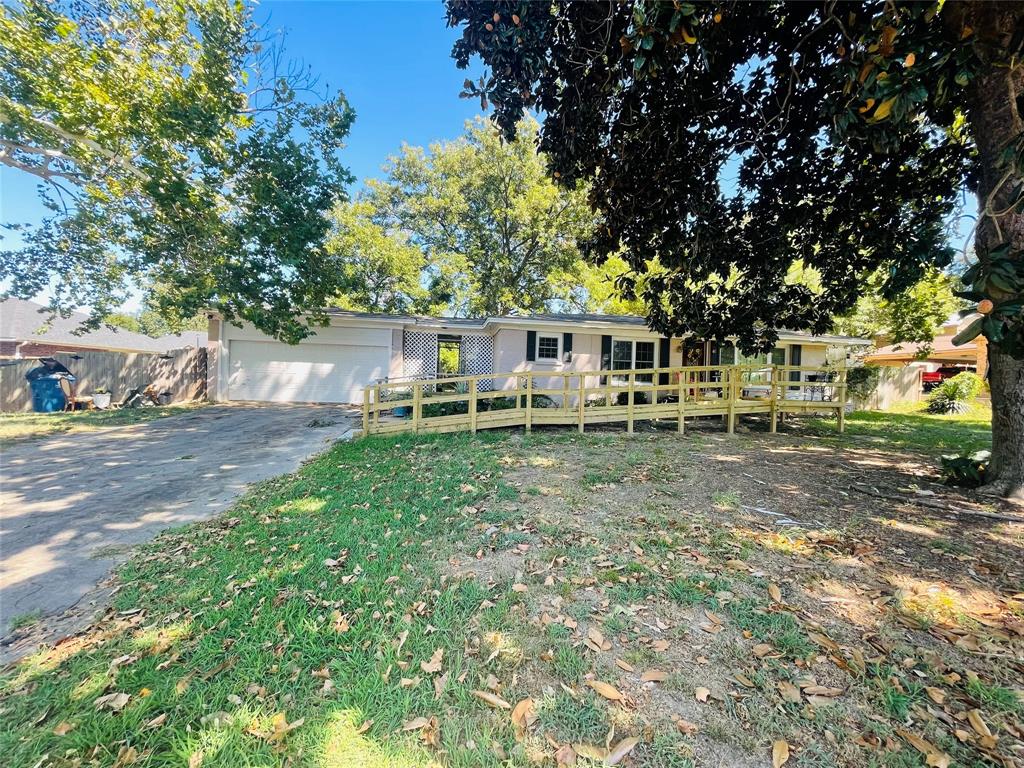 a view of a house with a yard and sitting area