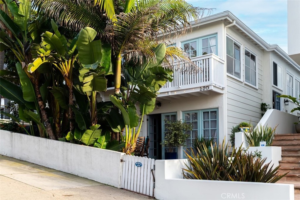 front view of house with potted plants