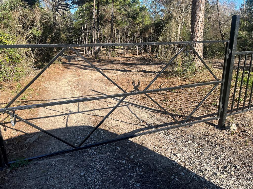 a view of a backyard with iron fence