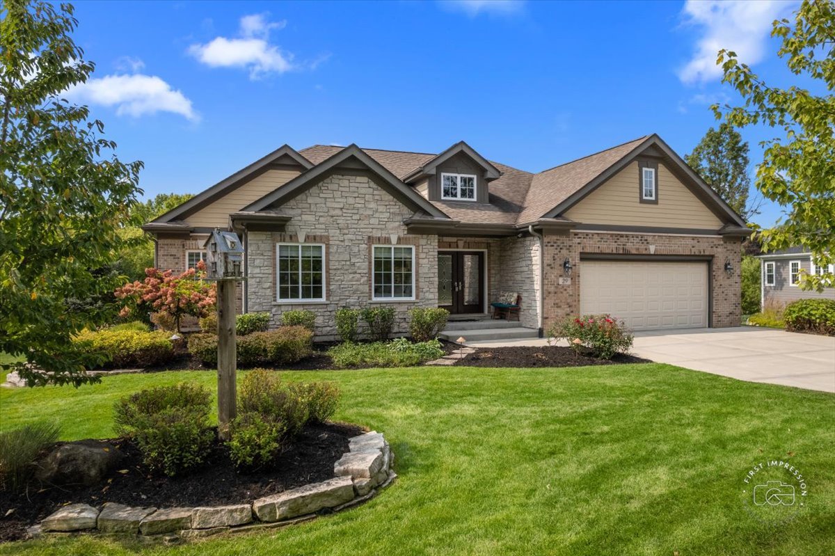 a front view of a house with a yard and garage