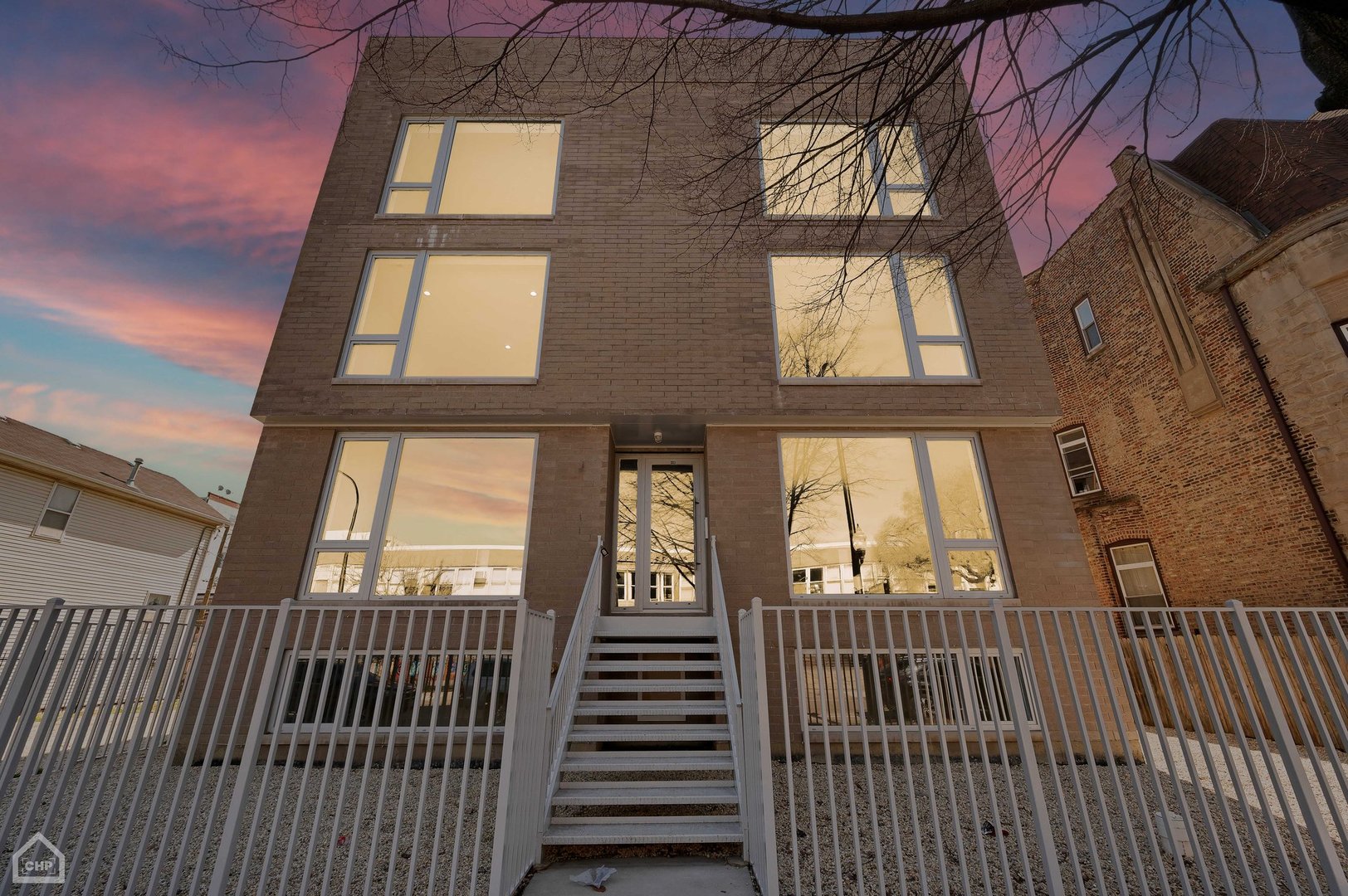 a view of a brick house with large windows