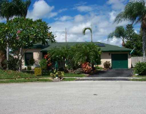 a front view of a house with a yard and outdoor seating