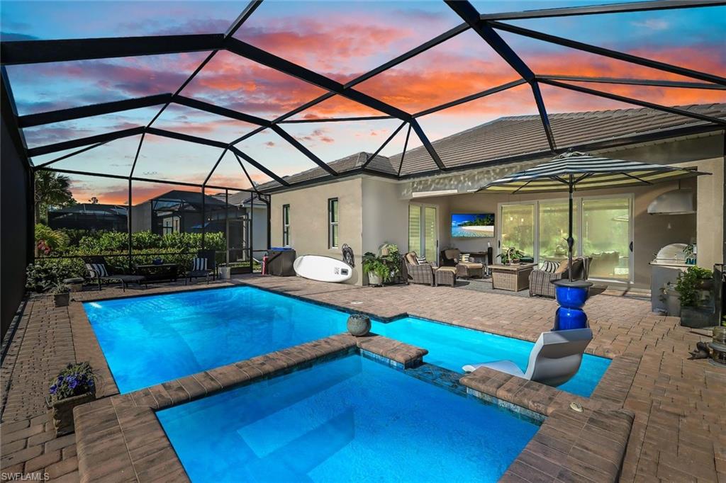 a view of swimming pool with seating area and furniture