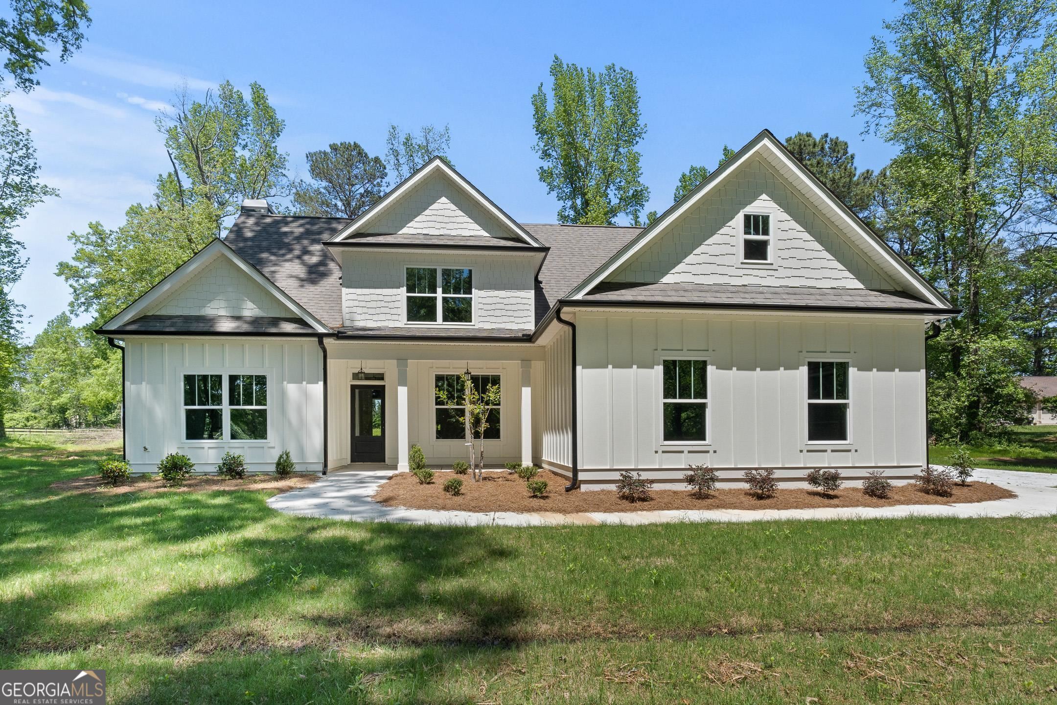 a front view of house with yard and green space