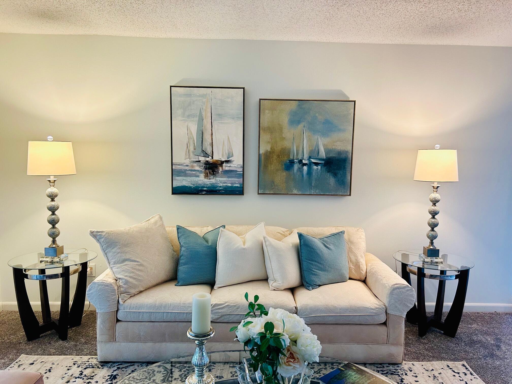 a living room with furniture and a painting on the wall