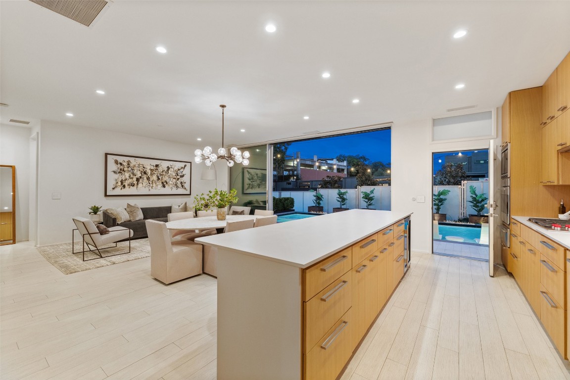 a large kitchen with lots of counter space a sink appliances and cabinets