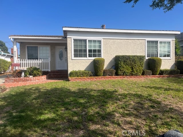 a view of house with backyard and glass door