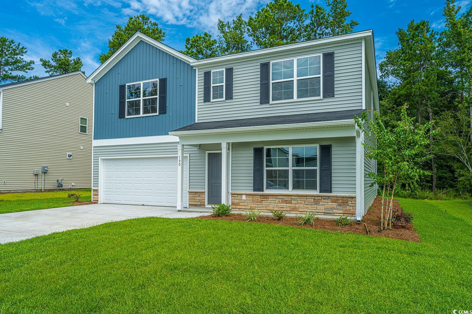 View of front of home featuring a garage and a fro