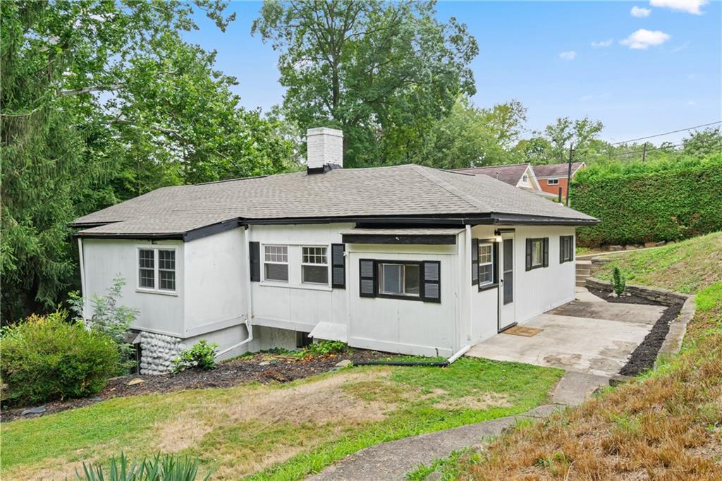 a house with trees in the background