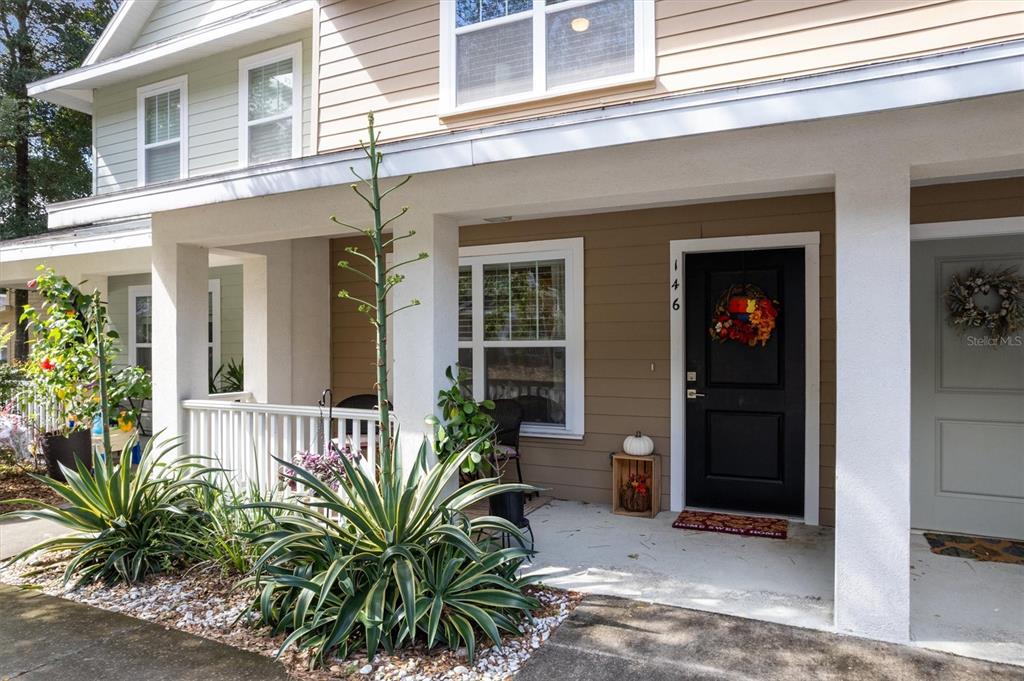 front view of a house with potted plants