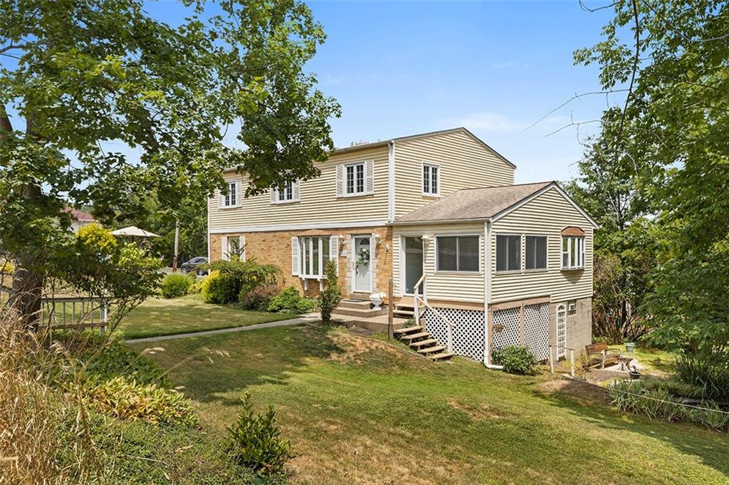 a front view of a house with a yard