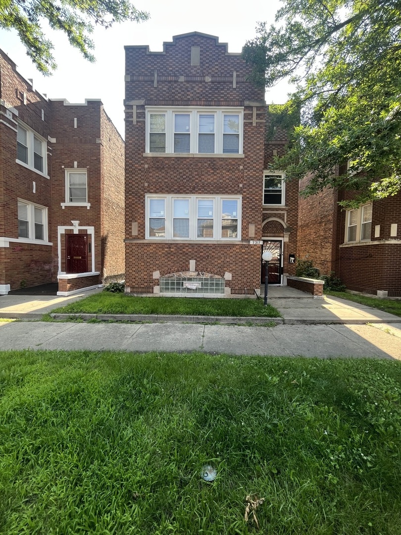 a front view of a house with a yard and garage