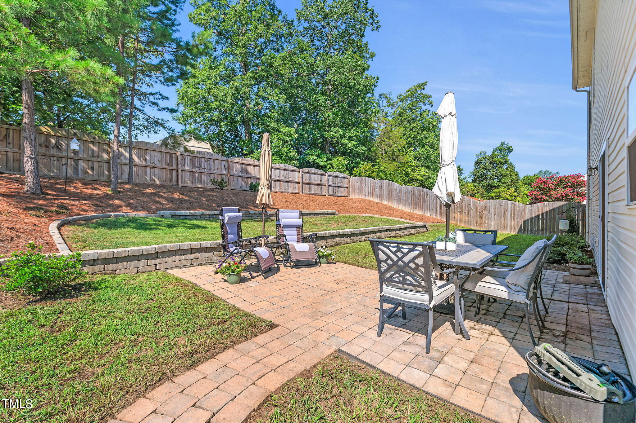 a view of a chairs and table in backyard