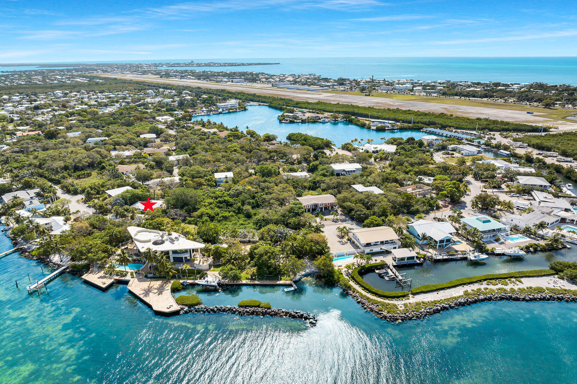 an aerial view of a house with a garden and lake view