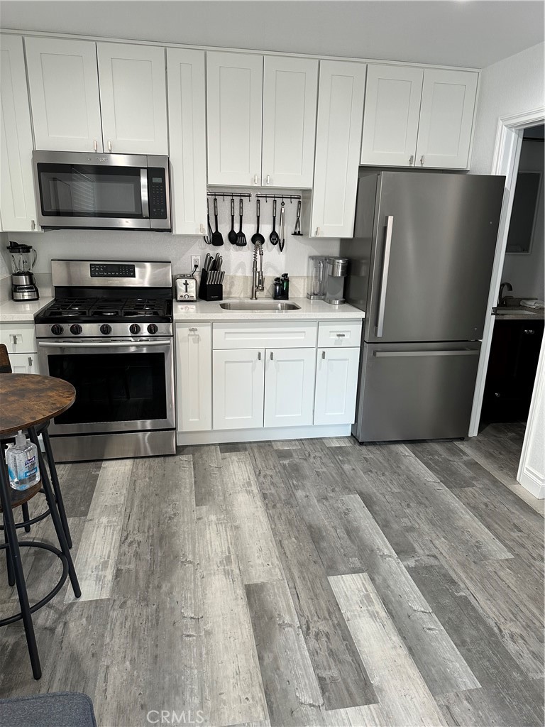 a kitchen with a refrigerator stove and microwave