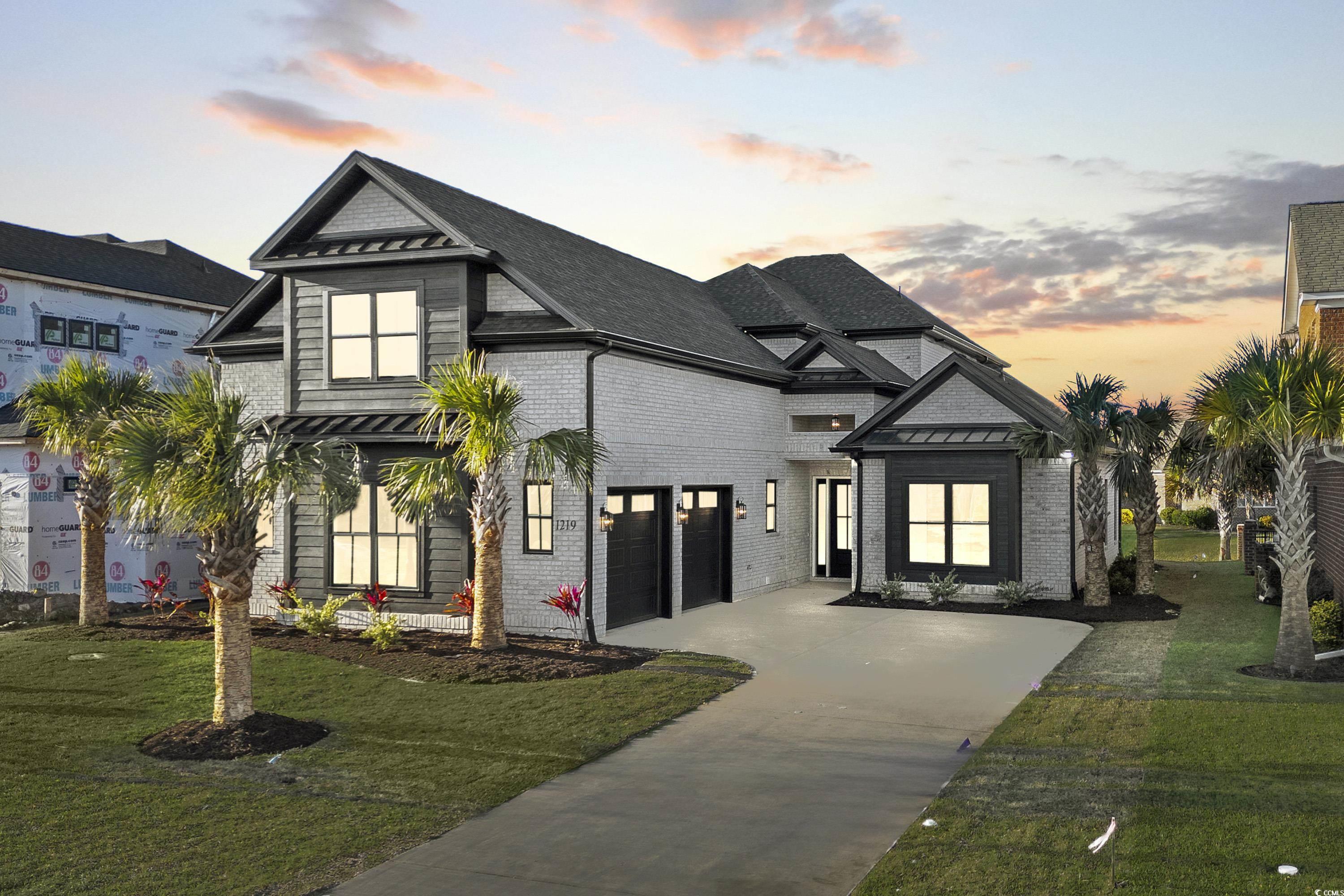 View of front of house with a lawn and a garage