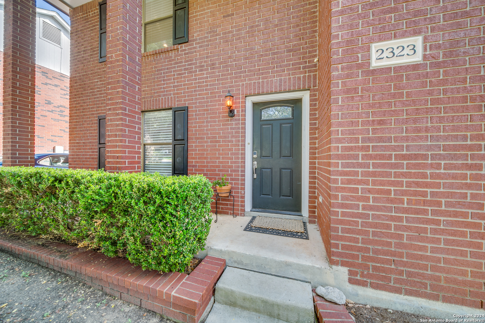 a view of a brick house with a yard