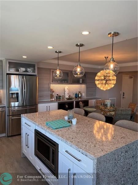 a kitchen with stainless steel appliances granite countertop a stove and a sink