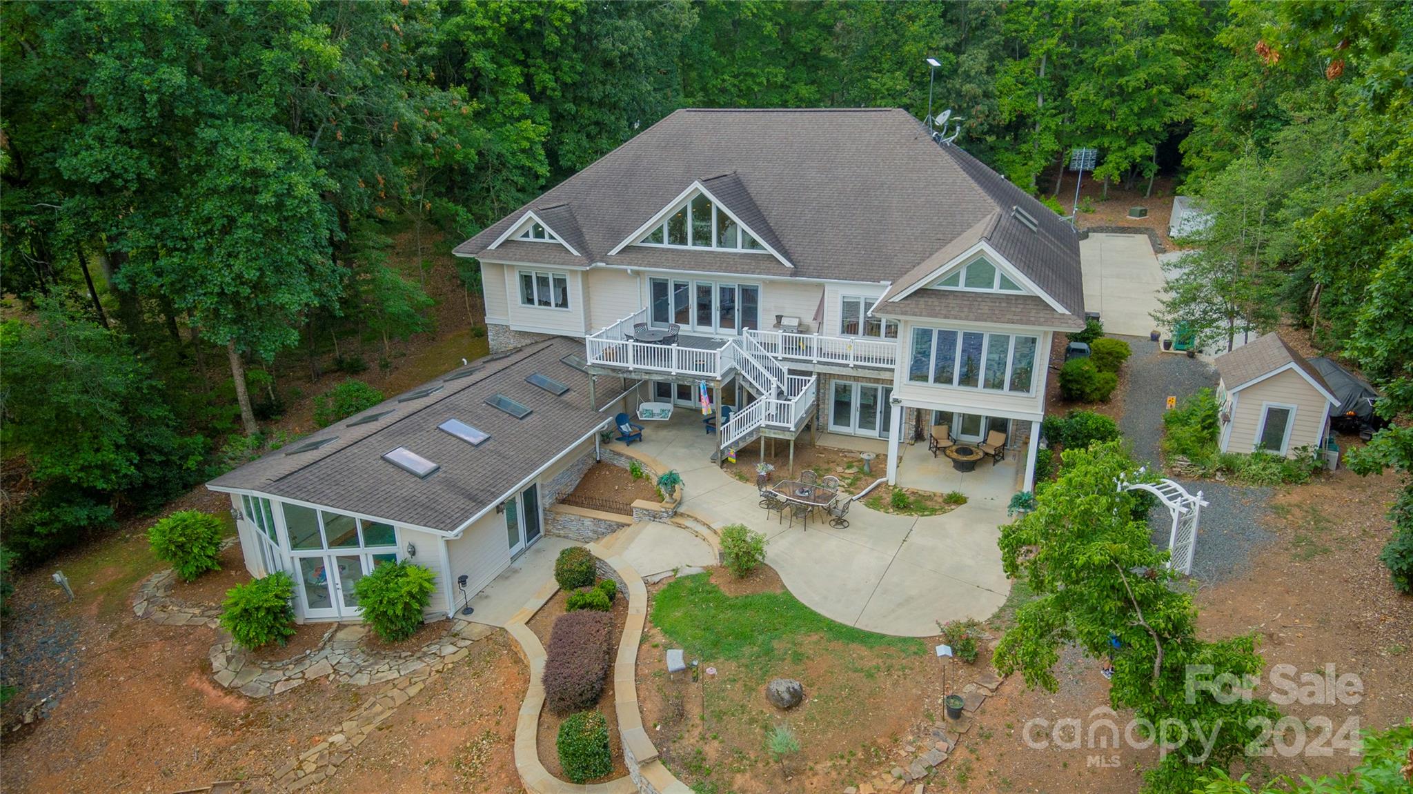 an aerial view of a house with swimming pool and garden