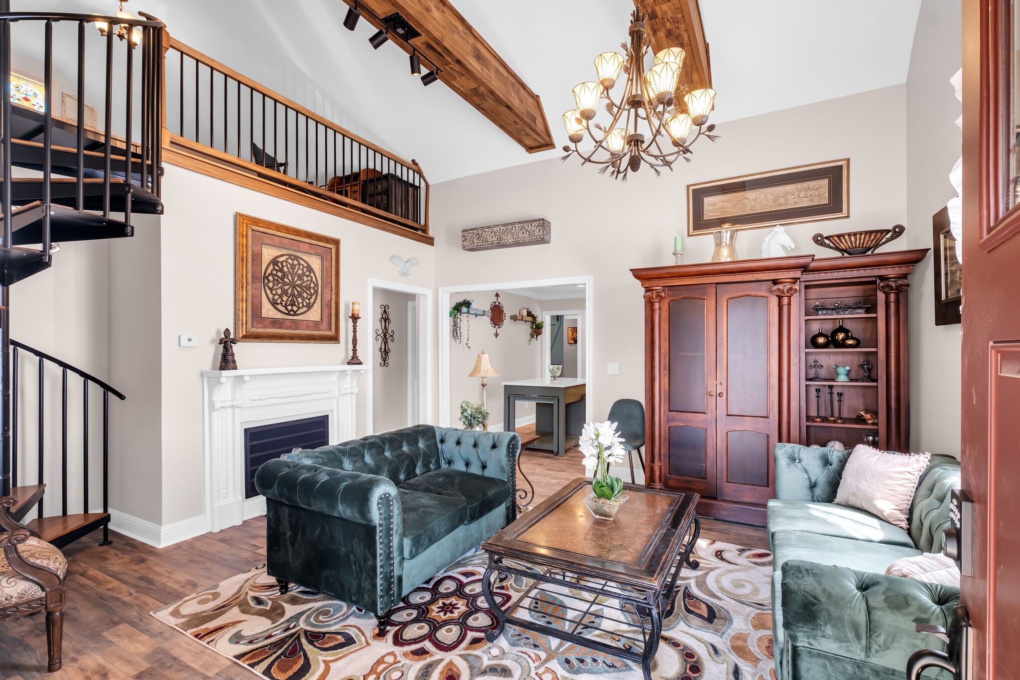 a living room with furniture a chandelier and a fireplace