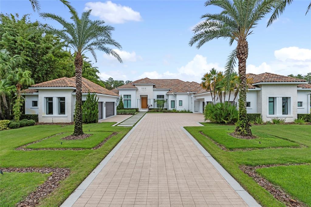 a front view of a house with a garden and yard