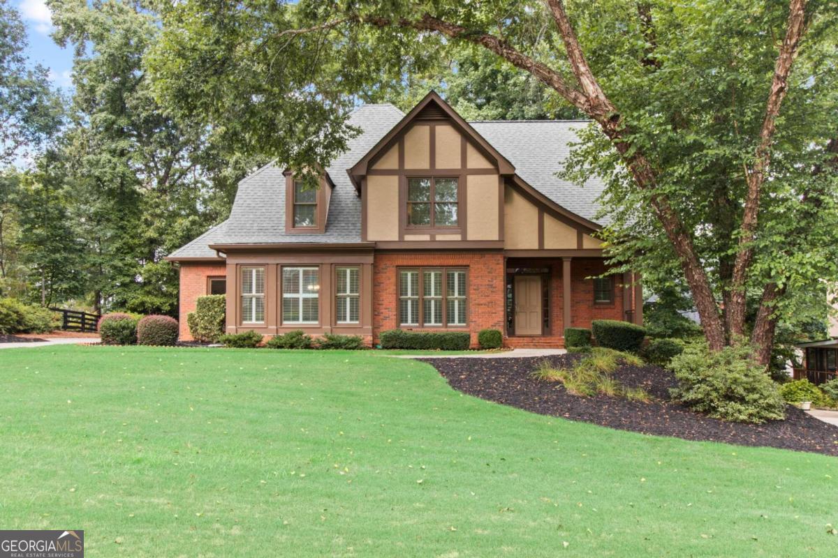 a front view of a house with a garden