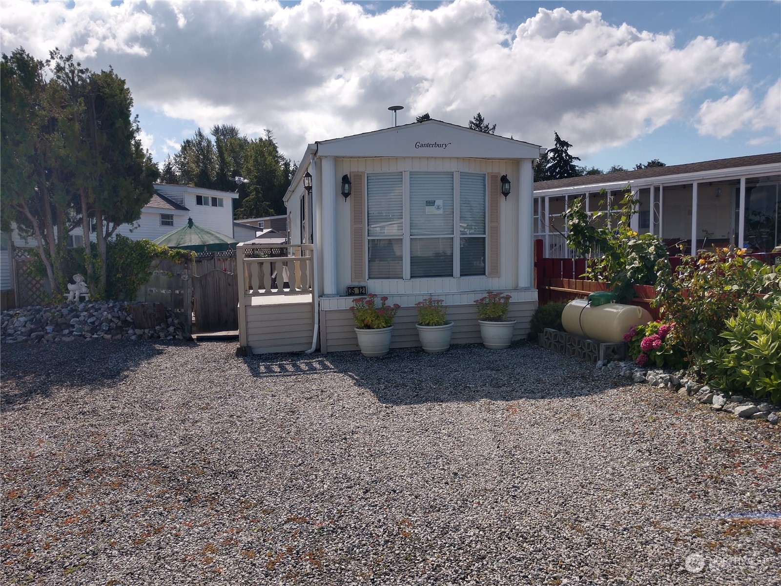 a front view of a house with a garden