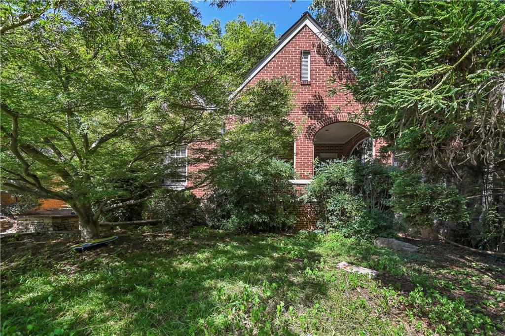 a aerial view of house with yard and outdoor seating