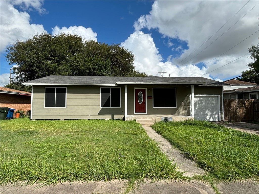 a front view of house with yard and green space