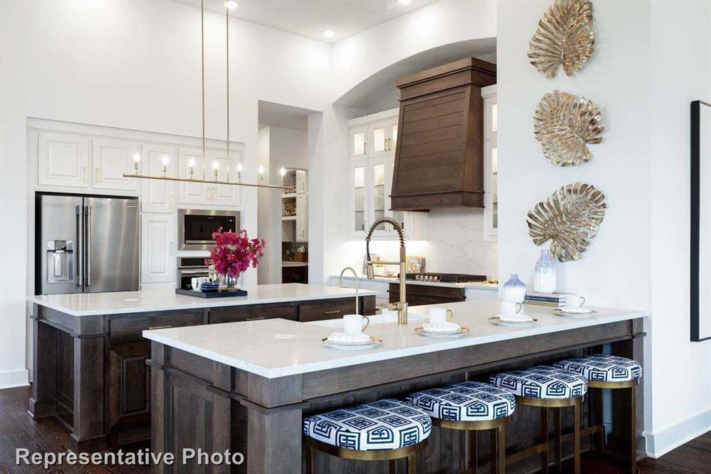 a kitchen with a sink dishwasher a stove and a refrigerator with wooden floor