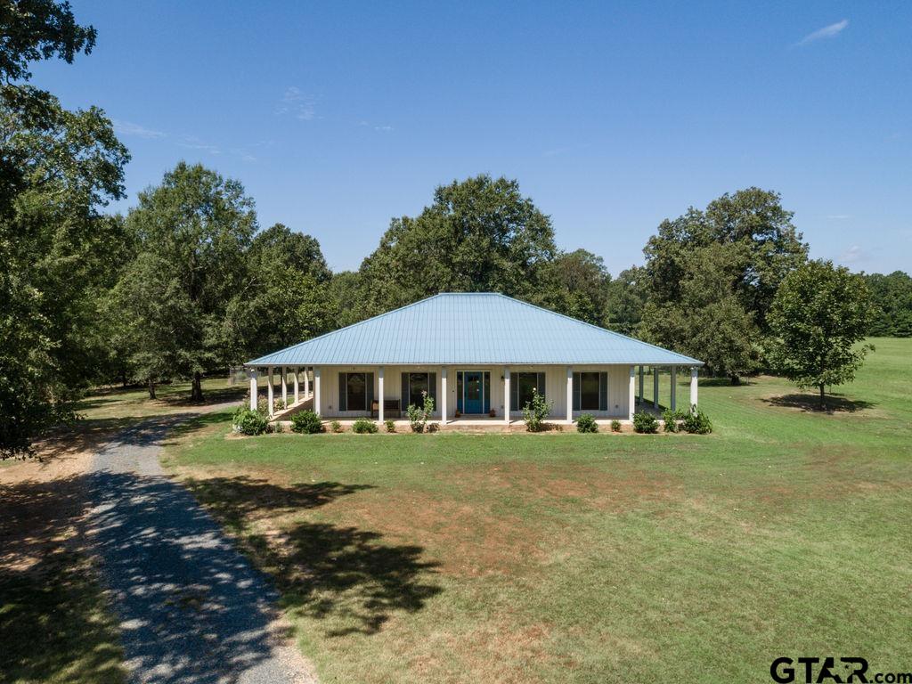 a white house sitting in middle of a field