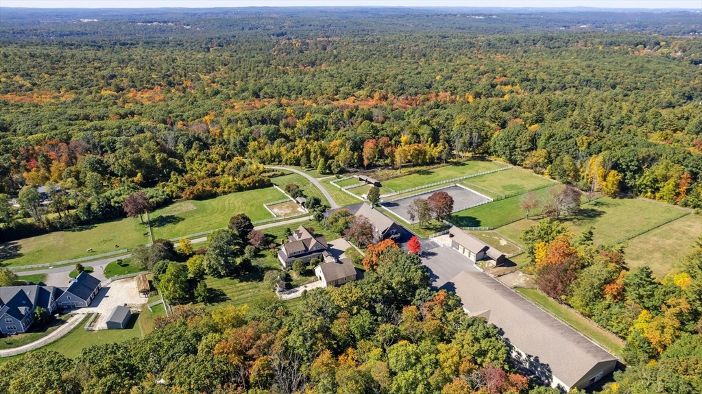 an aerial view of a houses with a yard