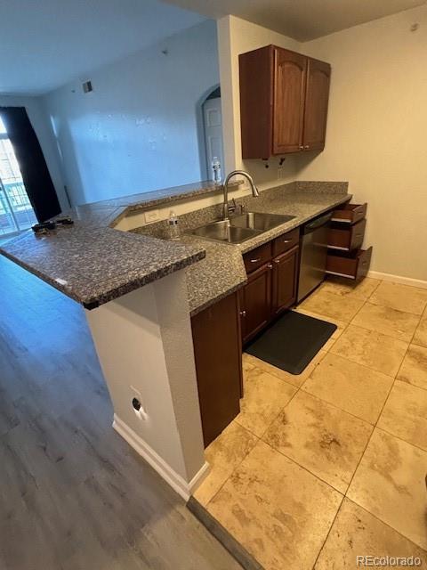 a kitchen with stainless steel appliances granite countertop a sink a stove and a microwave