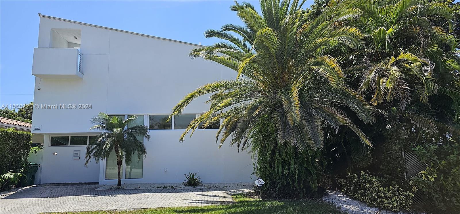 a view of a palm trees in front of a house