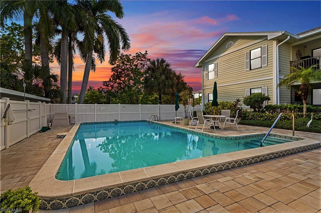 Pool at dusk with a patio